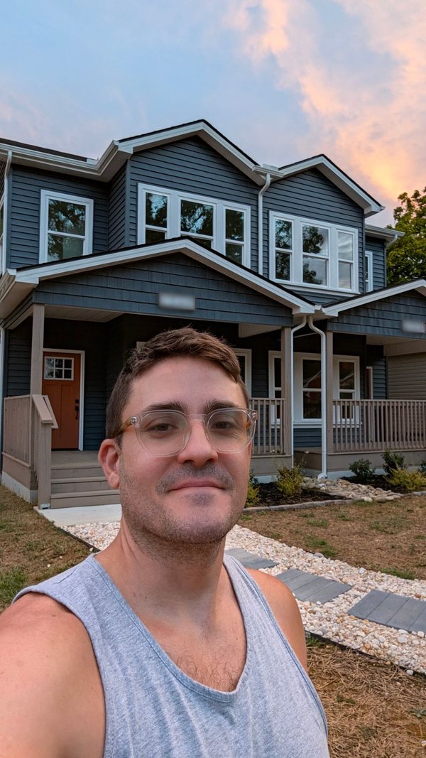 Adam in front of the house at sunset